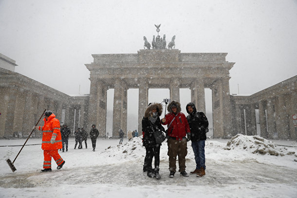 Туристы фотографируются возле Бранденбургских ворот в Берлине
