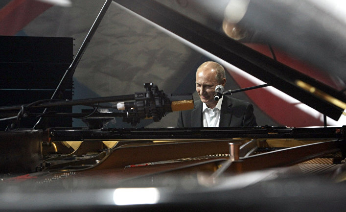 Vladimir Putin behind a grand piano. Archival photo